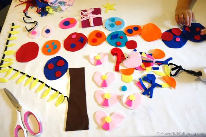 Cut out various color felts in circles, triangles, candy cane, presents stars and anything else that comes to mind.