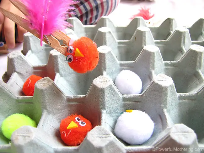 Pincer grasp activity with a clothespin mommy bird feeding pipe cleaner worms to pom pom chicks